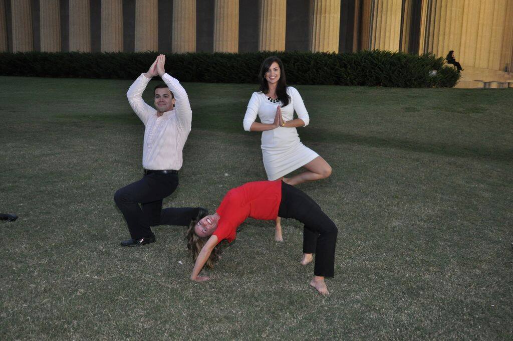 Reed PR employees doing yoga poses in Centennial Park
